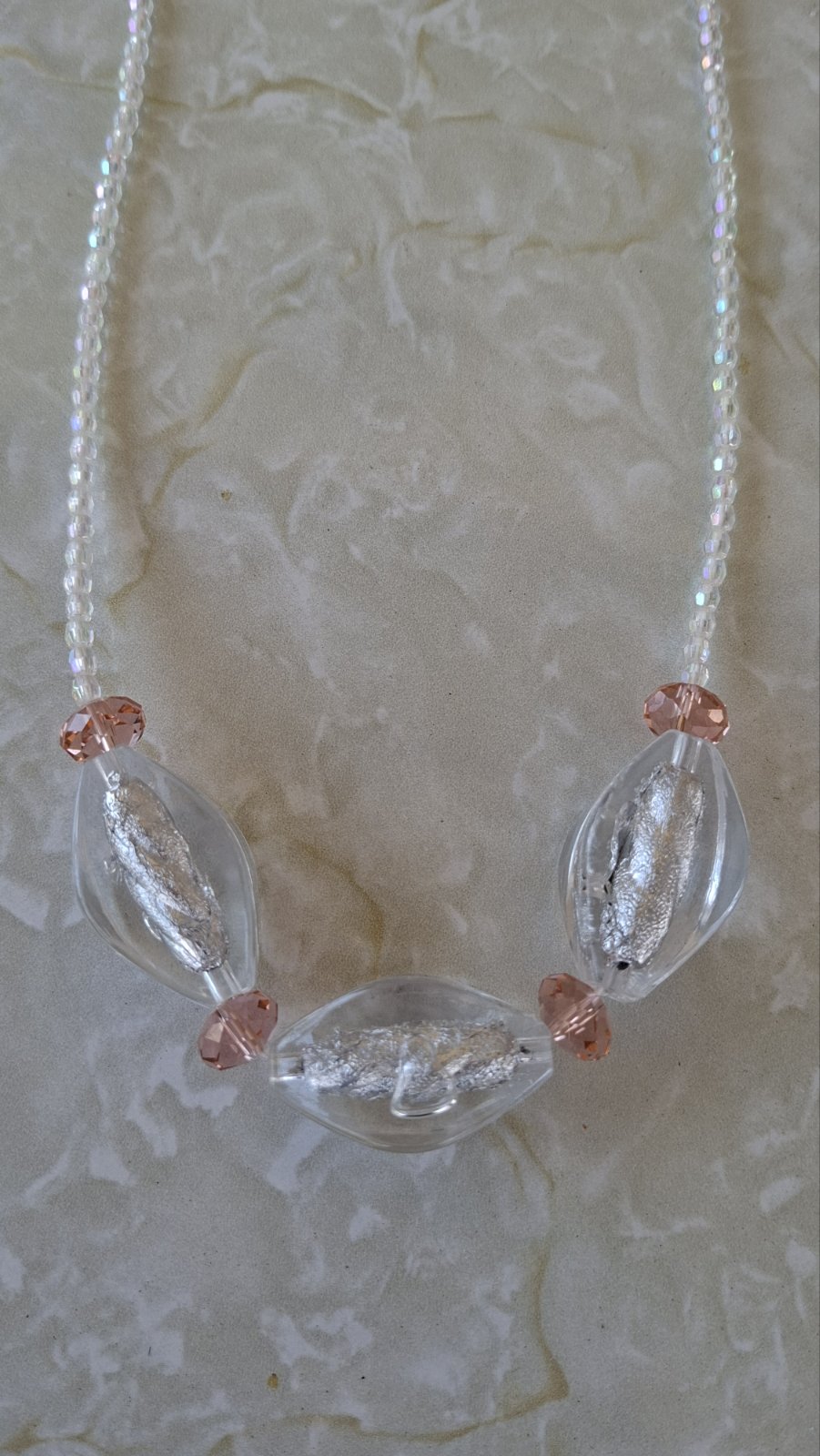 Close-up of triple stone crystal necklace focal beads on white background