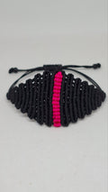Handmade black macramé bracelet with pink accent stripe - back view