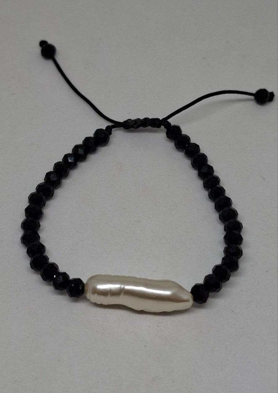 Close-up of natural white pearl and black beads on handmade bracelet – Georgia Create Cyprus