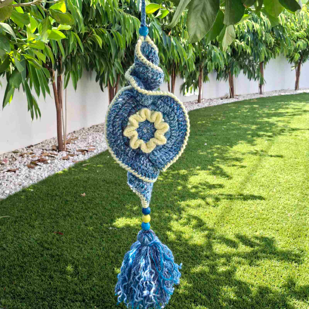 Handmade crochet garden hanging decoration with evil eye spiral design in blue and cream – Georgia Create Cyprus
