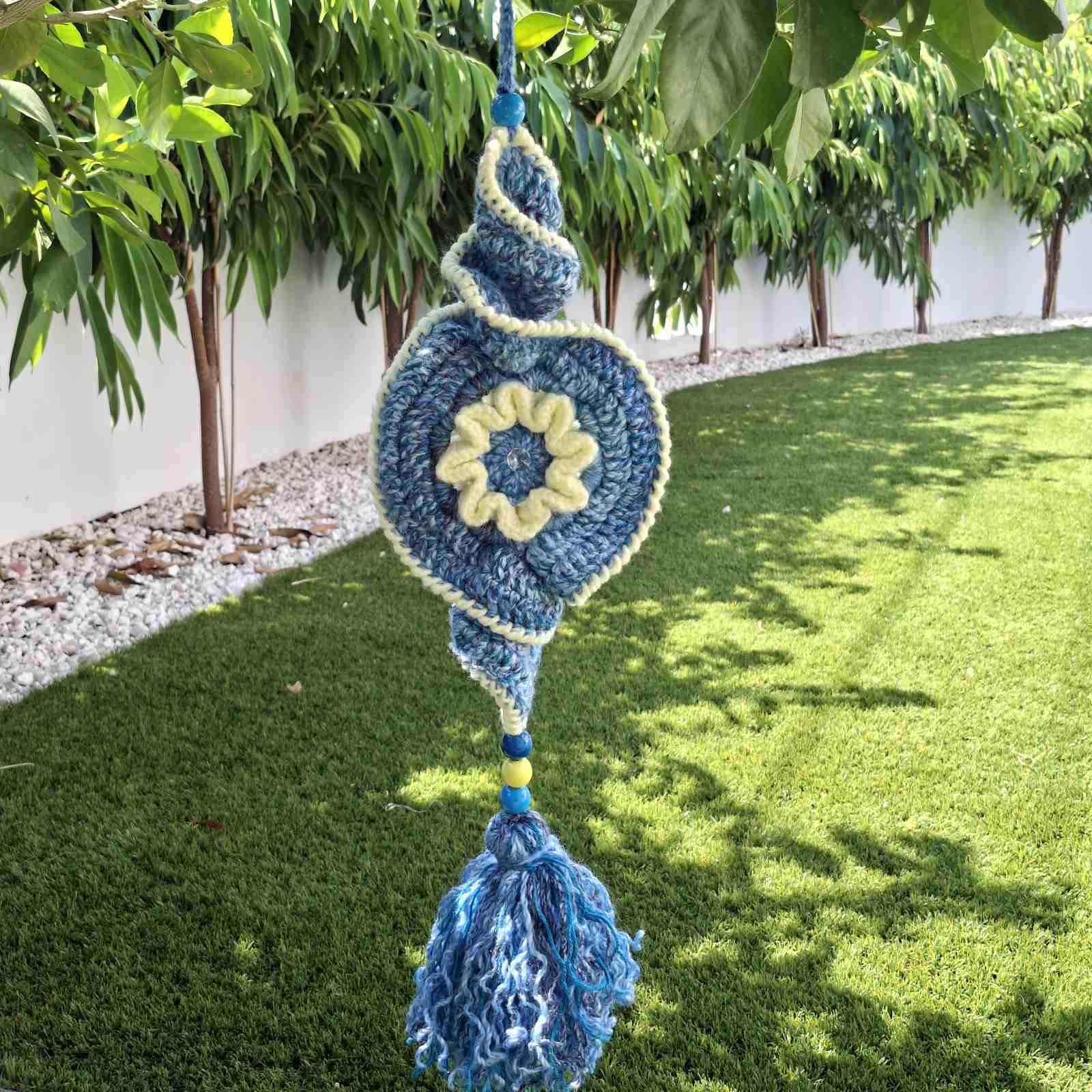 Handmade crochet garden hanging decoration with evil eye spiral design in blue and cream – Georgia Create Cyprus