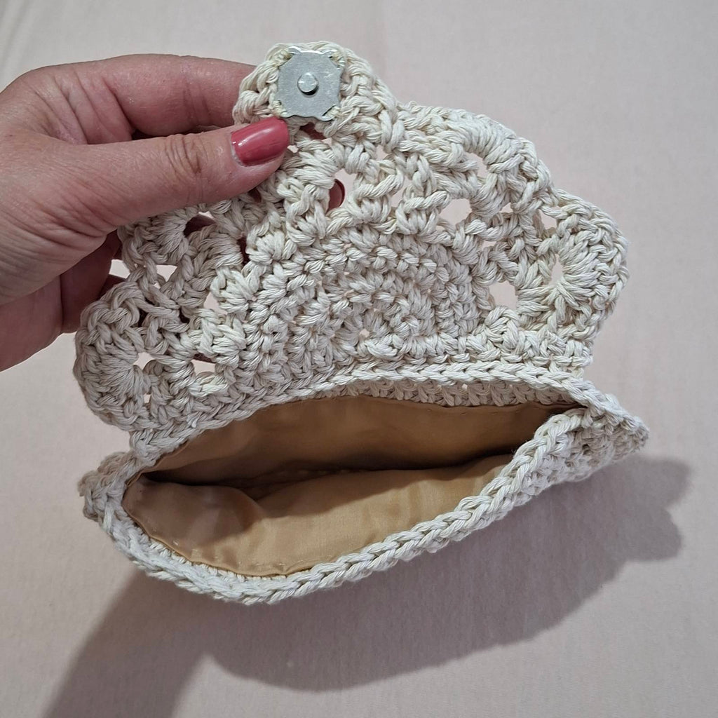 Open crochet glasses case showing fabric lining and magnetic snap