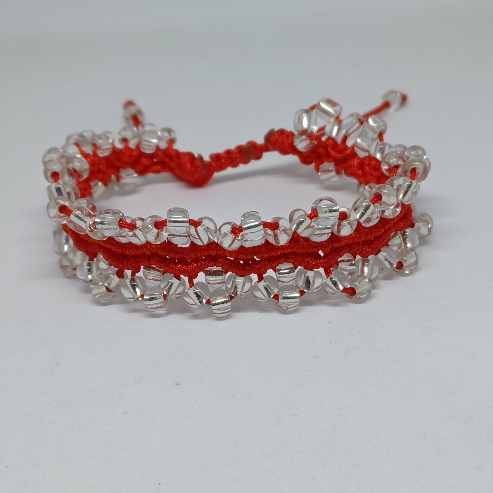 Red macramé bracelet with clear beads and adjustable sliding knot closure