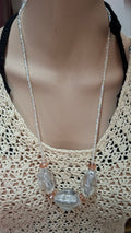 Triple stone crystal necklace worn on mannequin with crochet top